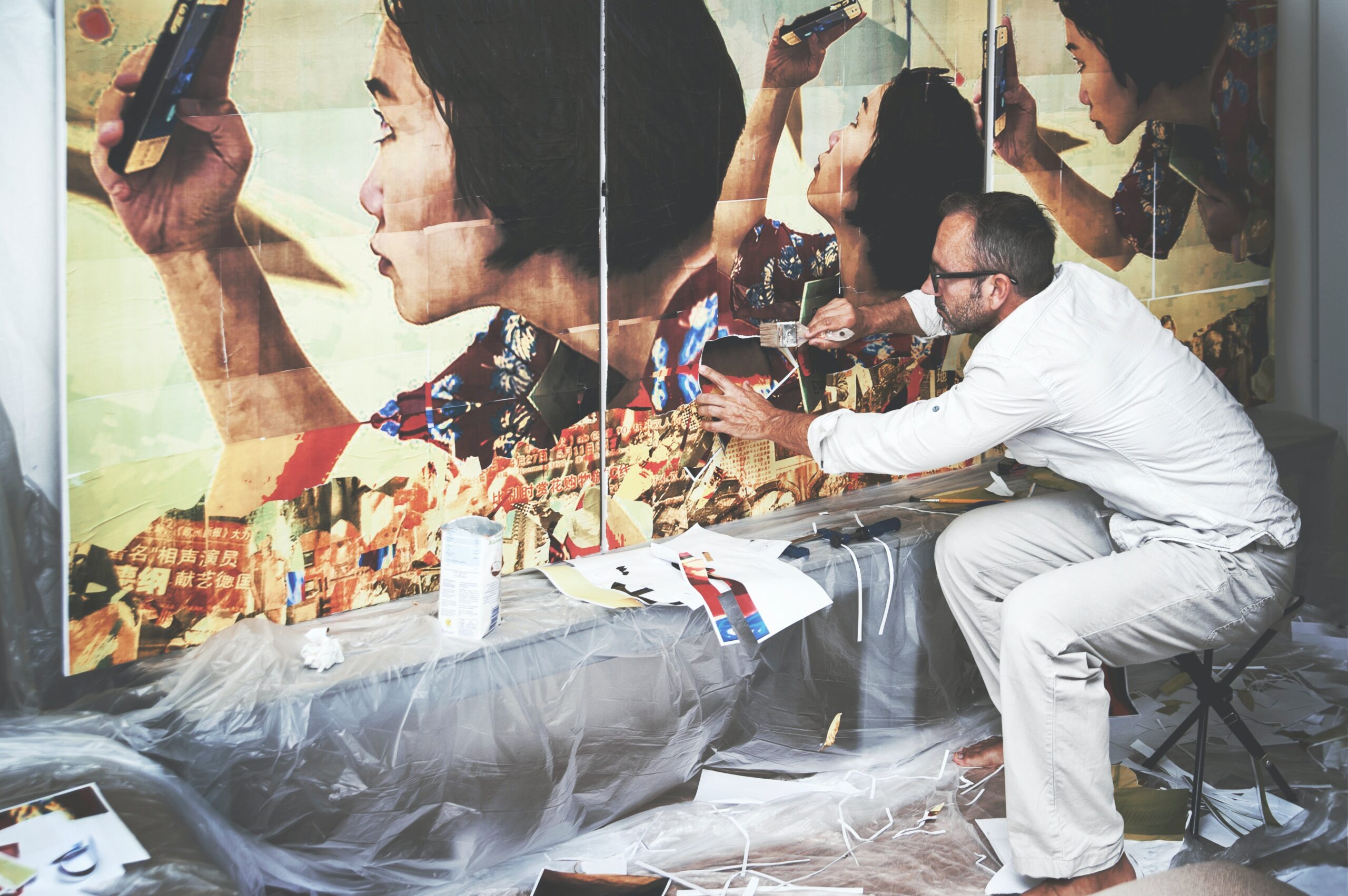 Artist painting a large artwork in a studio